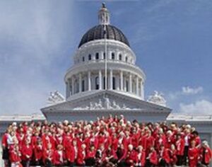Republican women wearing red shirts and standing in front of the capitol building.